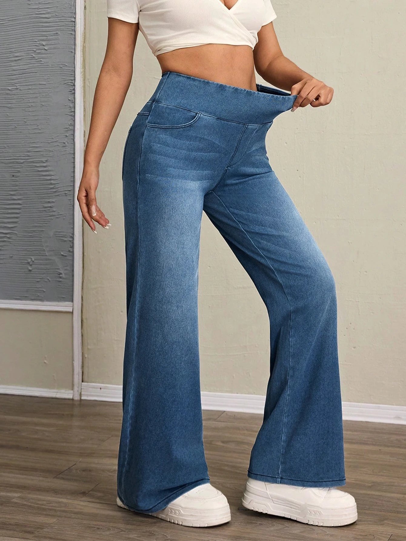 Women's high-rise wide-leg jeans with tummy tuck, slim fit, made from stretch denim fabric, are stylish for casual everyday wear
